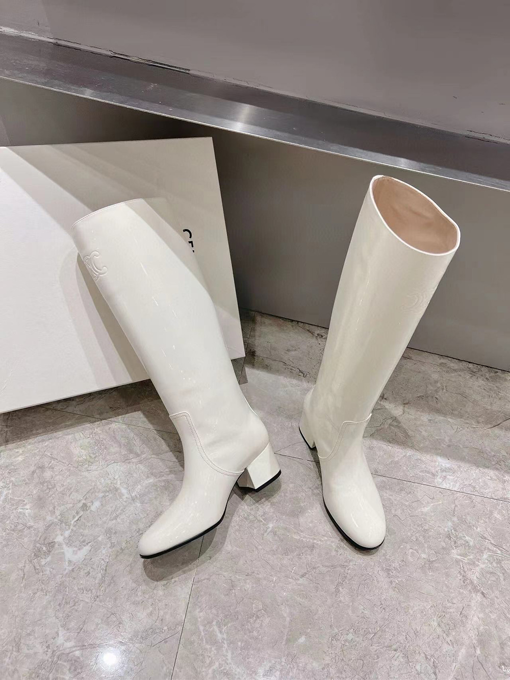 Ce**e triomphe high boot in patent calfskin